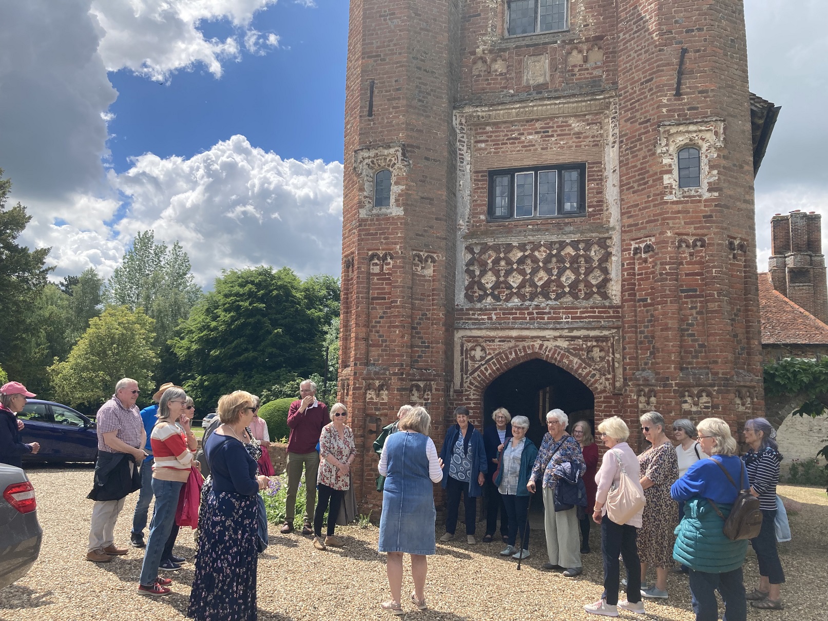 A group of people in front of a tower at West Stow Hall